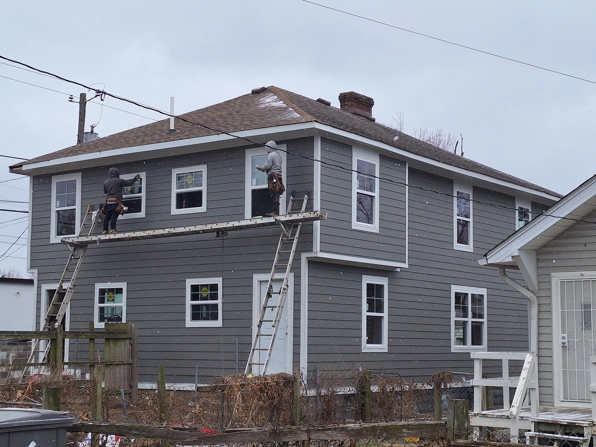 WOLO team installing exterior materials on a home
